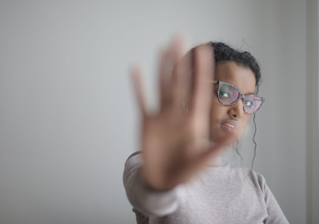 Woman holding her hand in a stop pose